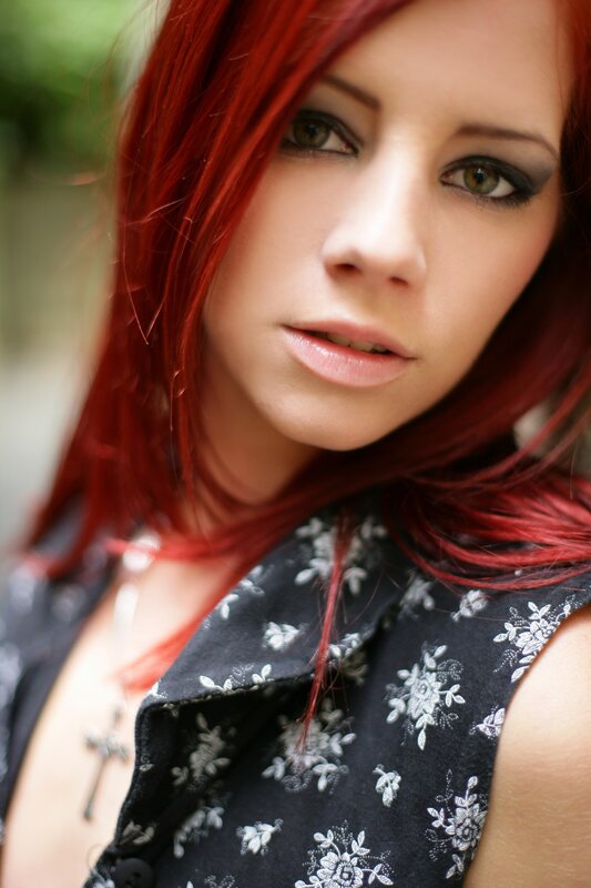woman with red hair and floral top