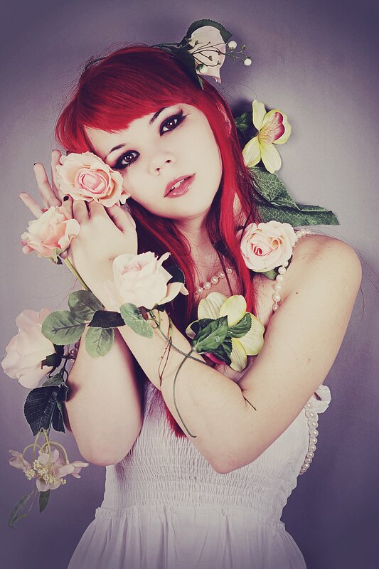 woman with red hair and flowers