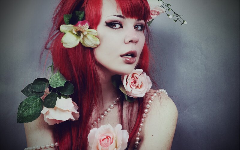 woman with red hair and flowers