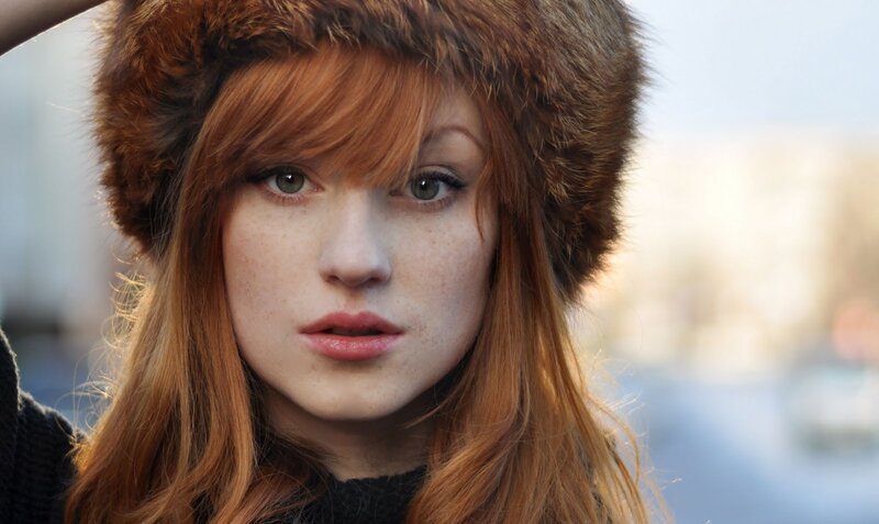 woman with red hair and fur hat