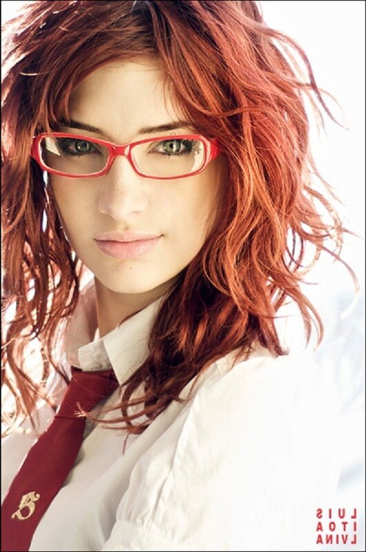 woman with red hair and glasses