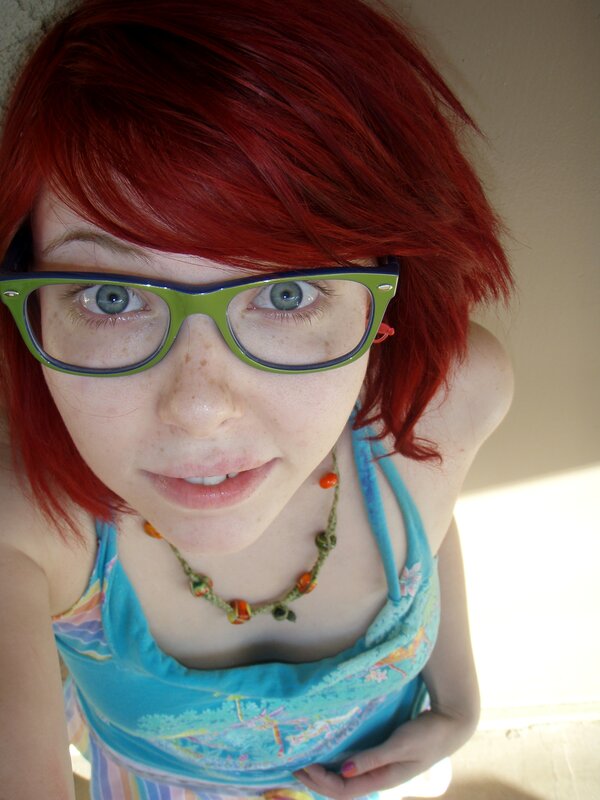 woman with red hair and glasses