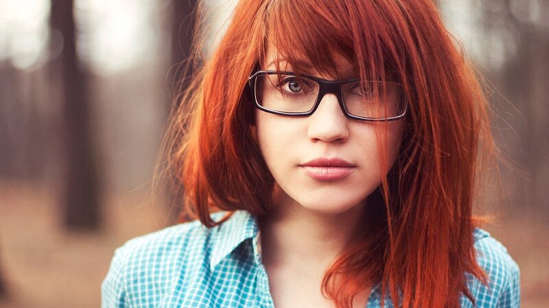 woman with red hair and glasses