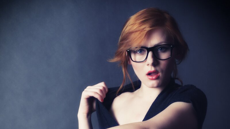 woman with red hair and glasses