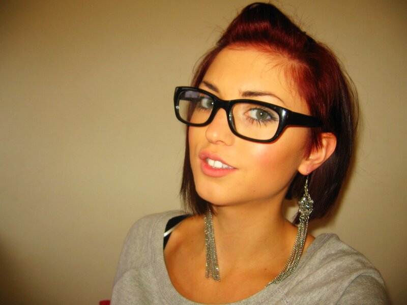 woman with red hair and glasses