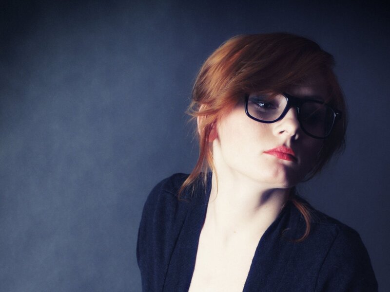 woman with red hair and glasses