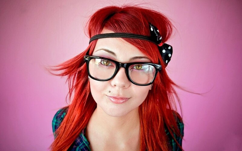 woman with red hair and glasses