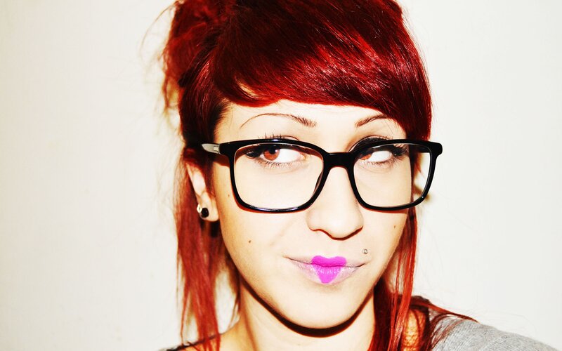 woman with red hair and glasses