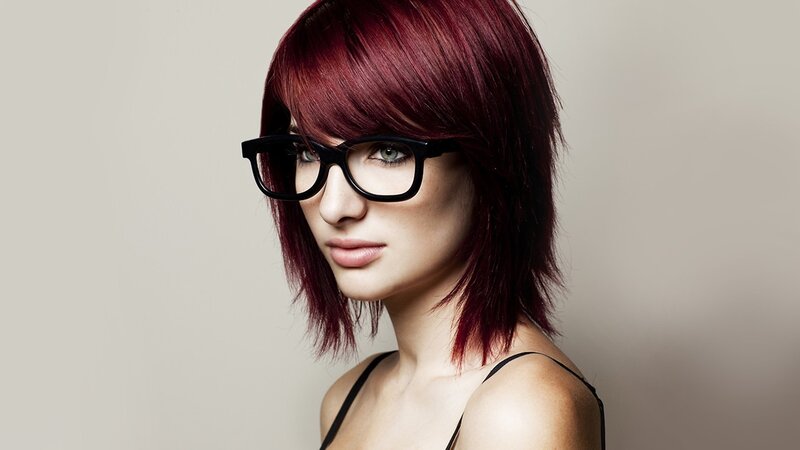 woman with red hair and glasses