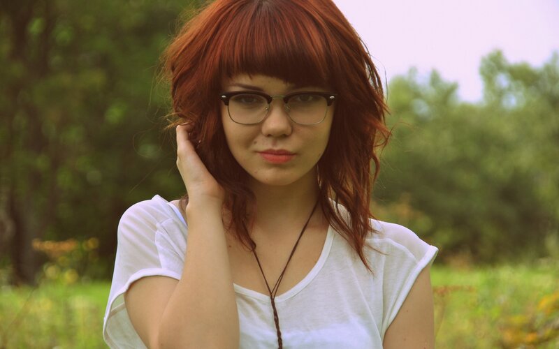 woman with red hair and glasses