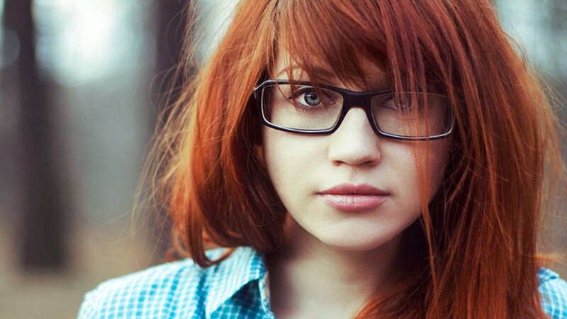 woman with red hair and glasses