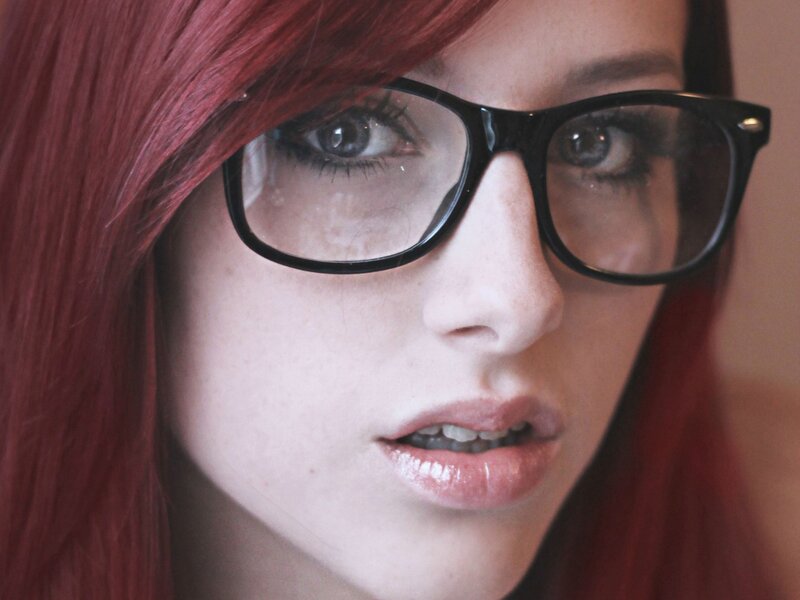 woman with red hair and glasses