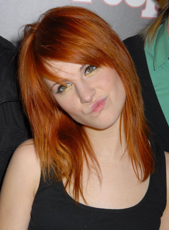 woman with red hair and gold makeup