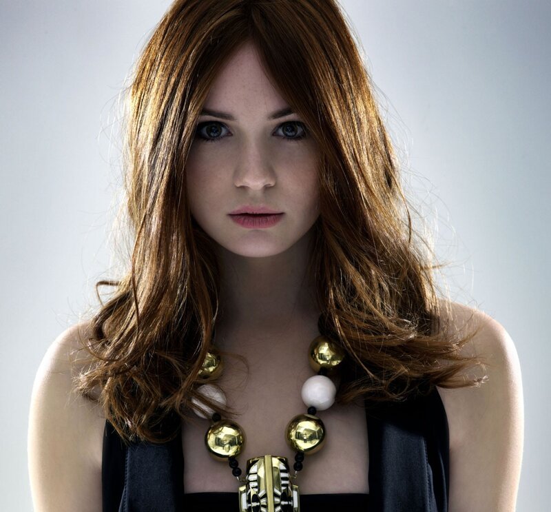 woman with red hair and gold necklace