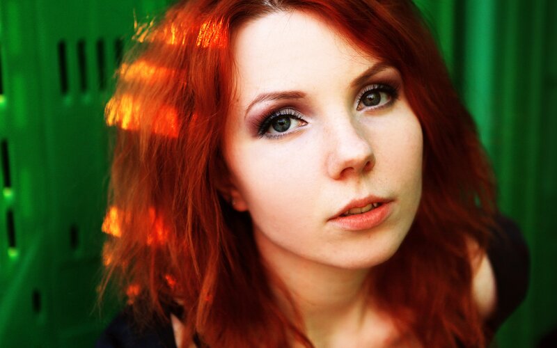 woman with red hair and green background