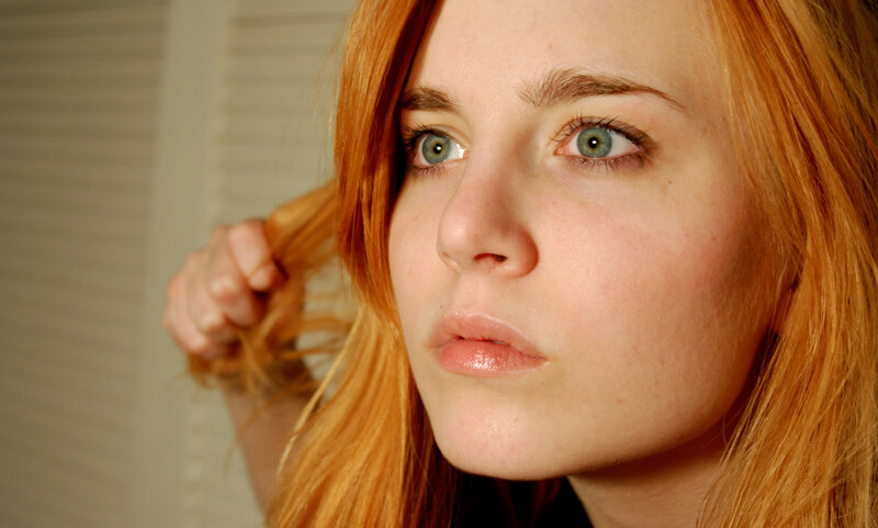 woman with red hair and green eyes