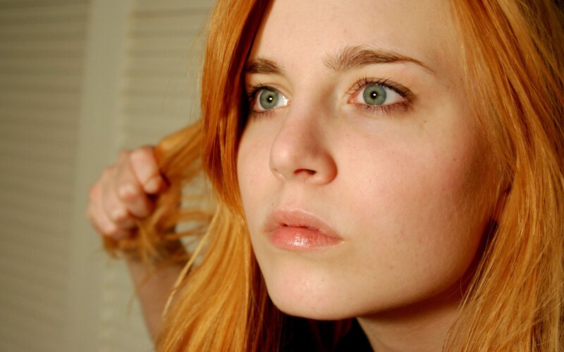 woman with red hair and green eyes
