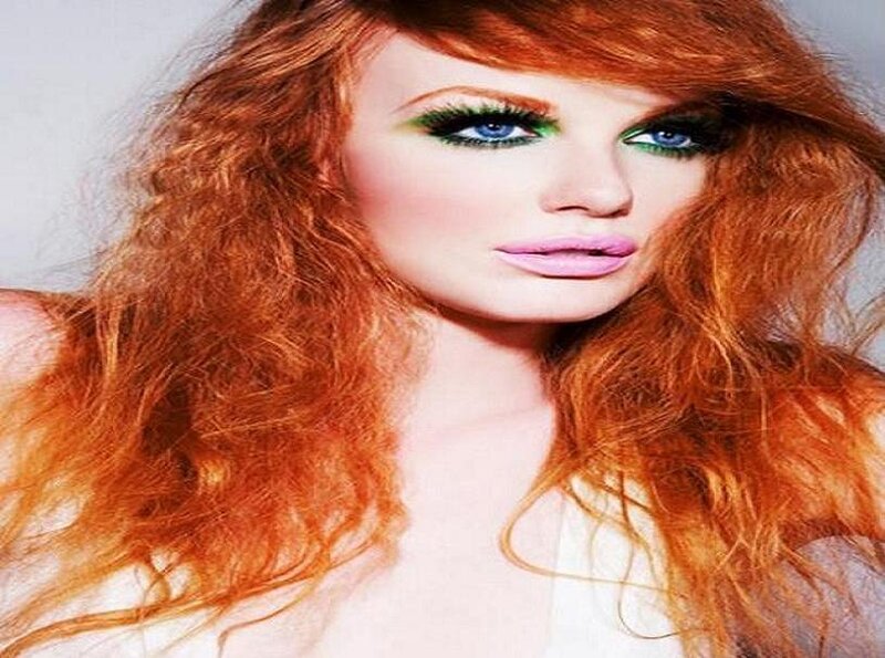 woman with red hair and green makeup