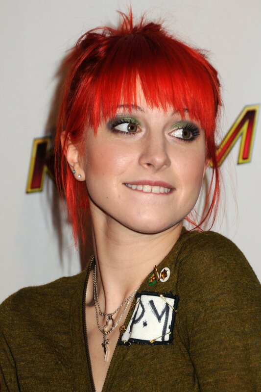 woman with red hair and green makeup