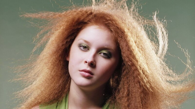 woman with red hair and green makeup