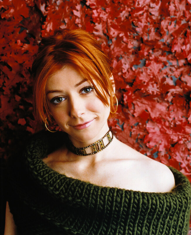 woman with red hair and green sweater