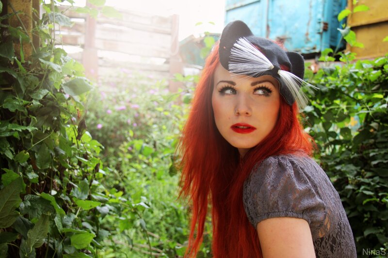 Woman with red hair and hat