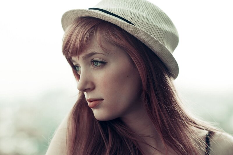 woman with red hair and hat