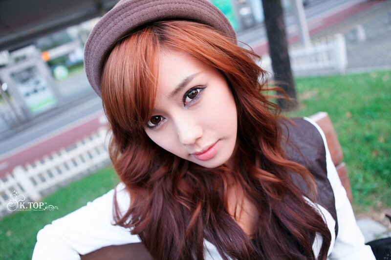 woman with red hair and hat
