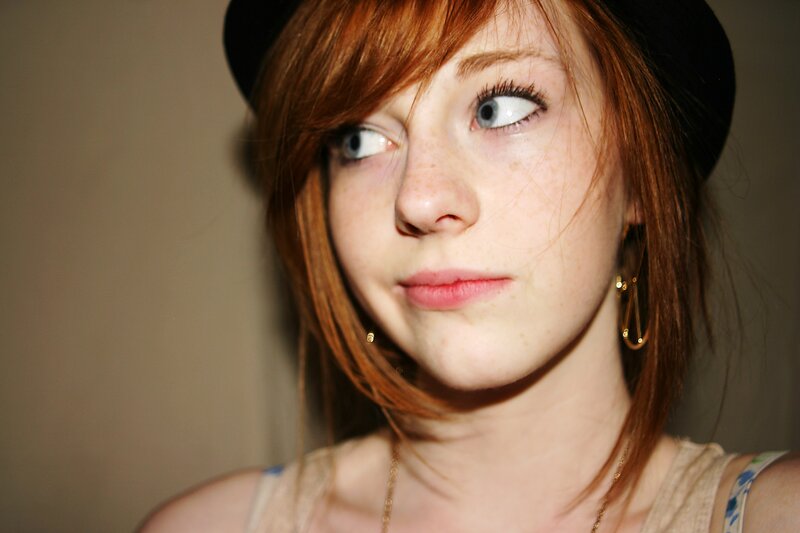 woman with red hair and hat