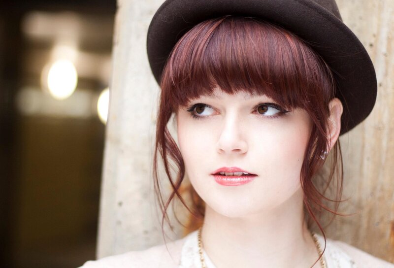 woman with red hair and hat