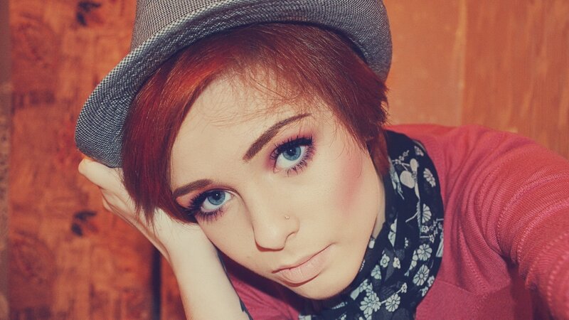 woman with red hair and hat