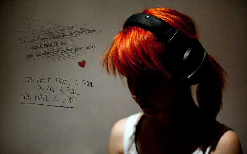 woman with red hair and headphones