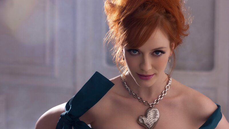 woman with red hair and heart necklace