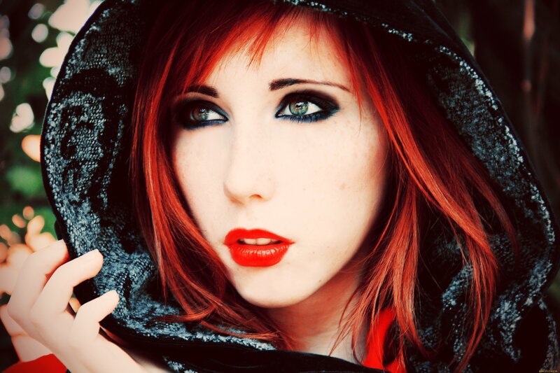 woman with red hair and hood
