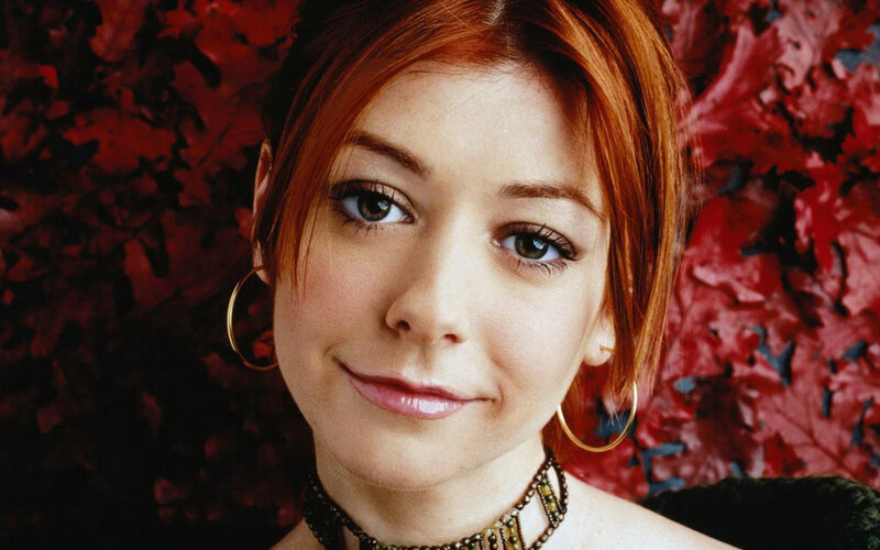woman with red hair and hoop earrings