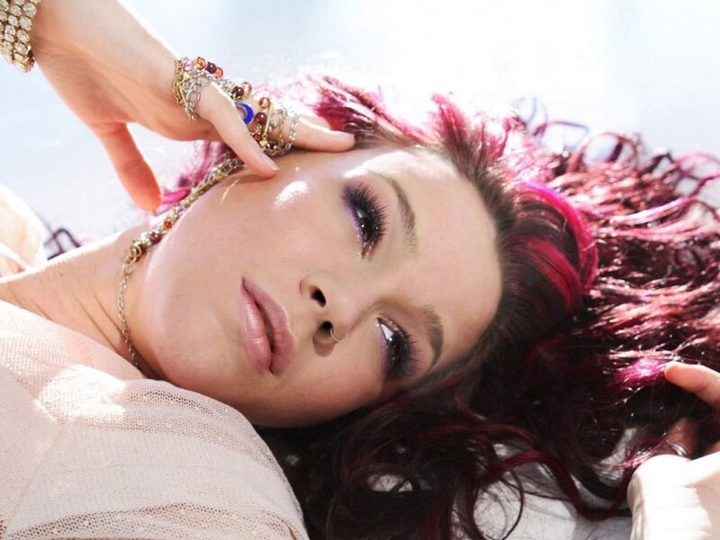 woman with red hair and jewelry