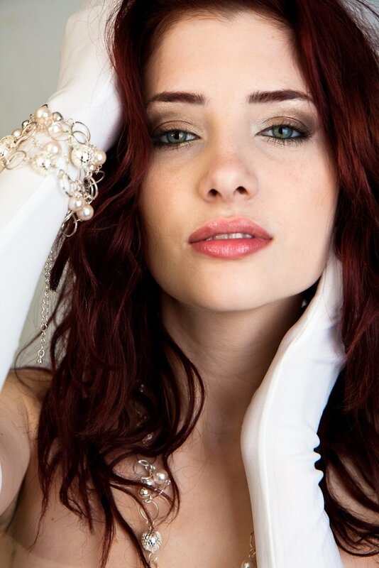 woman with red hair and jewelry