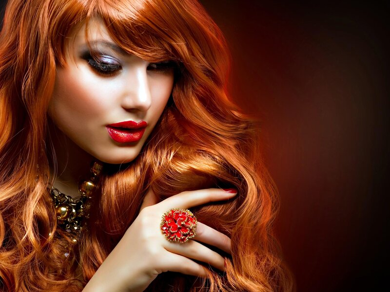 woman with red hair and jewelry