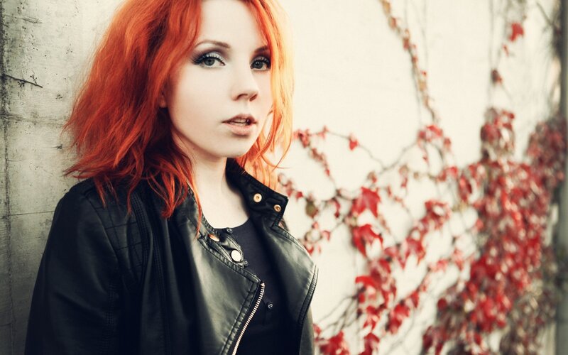 woman with red hair and leather jacket