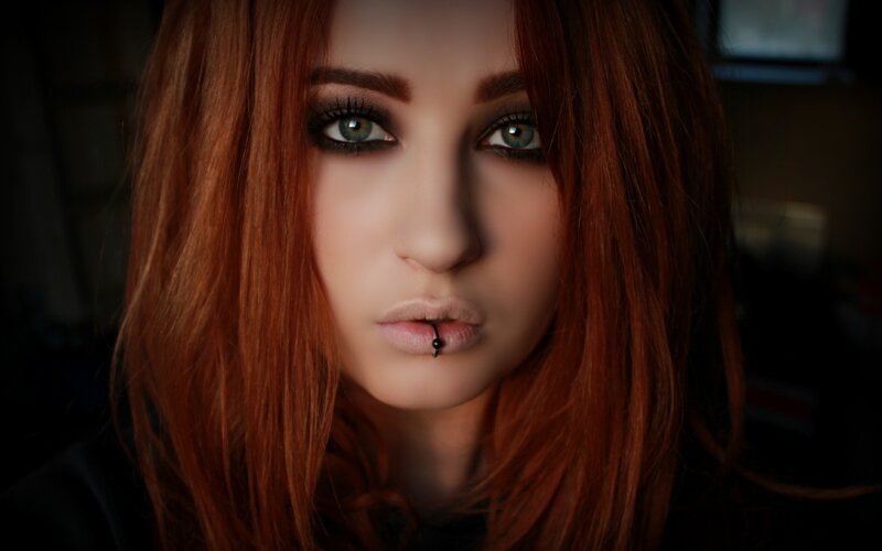 woman with red hair and lip piercing