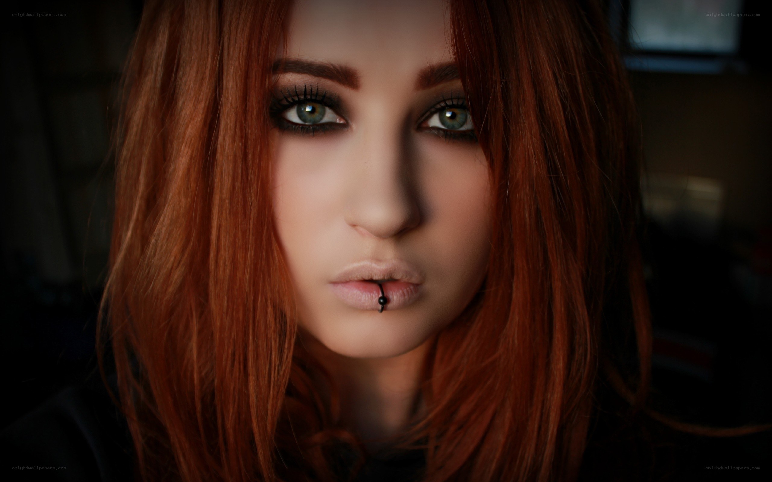 woman with red hair and lip piercing