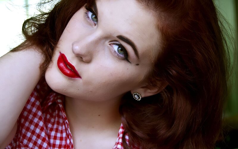 woman with red hair and lipstick