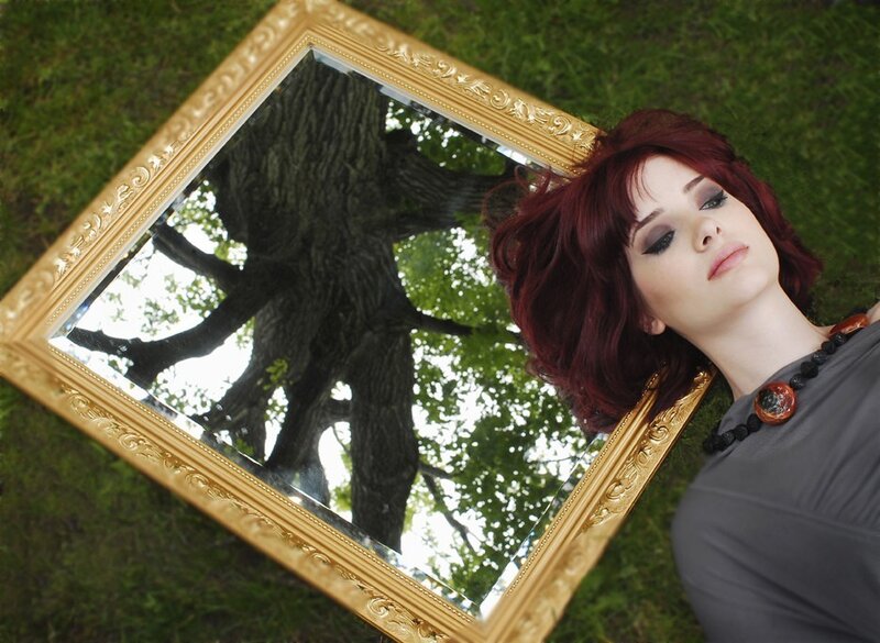 Woman with red hair and mirror