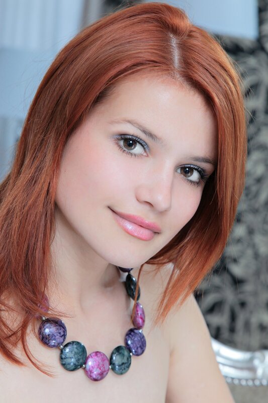 woman with red hair and necklace
