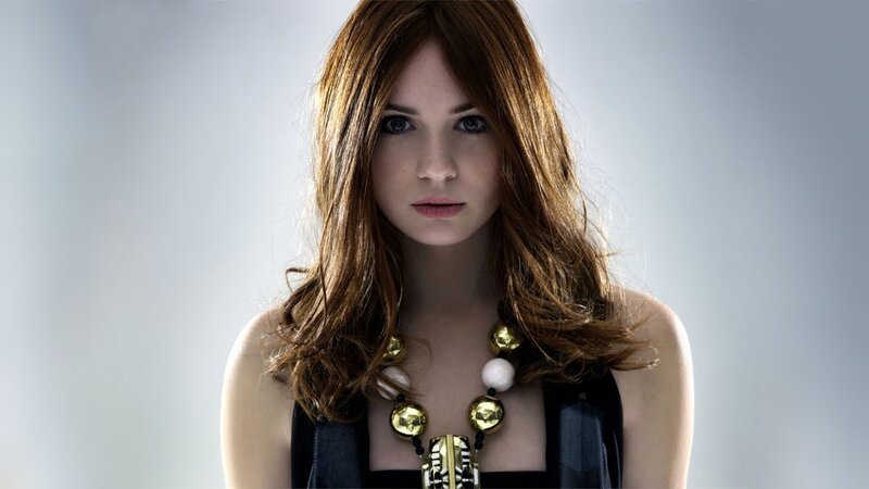 woman with red hair and necklace