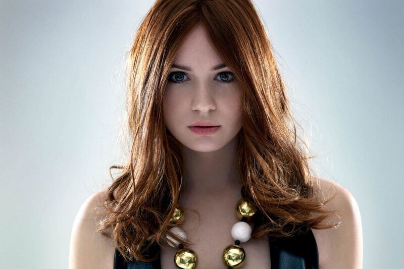 woman with red hair and necklace