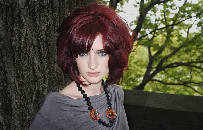 woman with red hair and necklace
