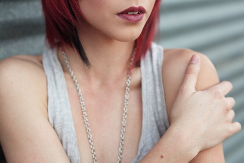 woman with red hair and necklace