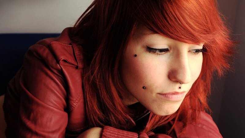 woman with red hair and piercings