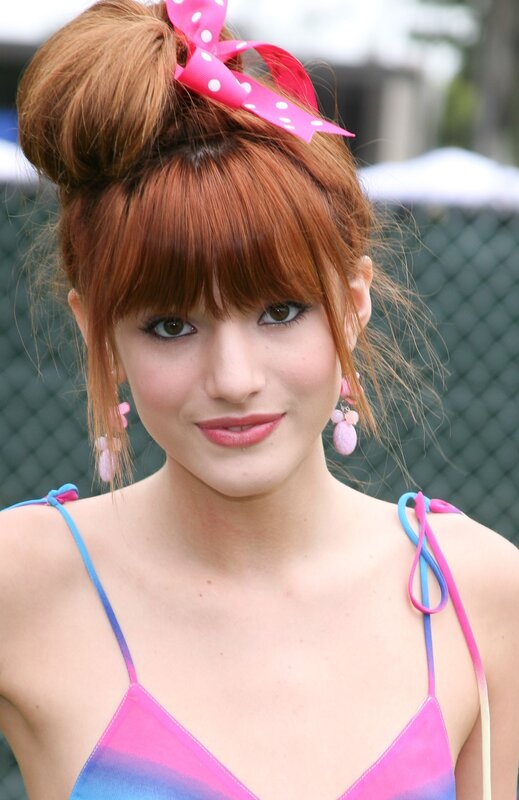 woman with red hair and pink bow